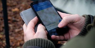Person holding phone with map app open